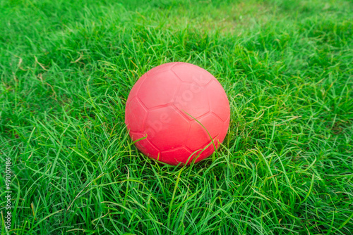 red soccer ball on grass