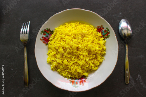 yellow rice or turmeric rice or nasi kuning is food made from  rice cooked with turmeric, coconut milk and spices. so the taste is more savory
