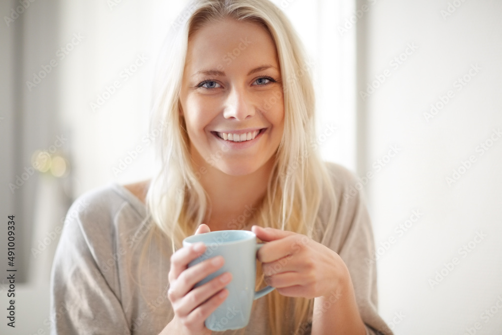 A boost in the morning. A pretty young woman enjoying a cup of coffee in the morning. A boost in the morning. A pretty young woman enjoying a cup of coffee in the morning.