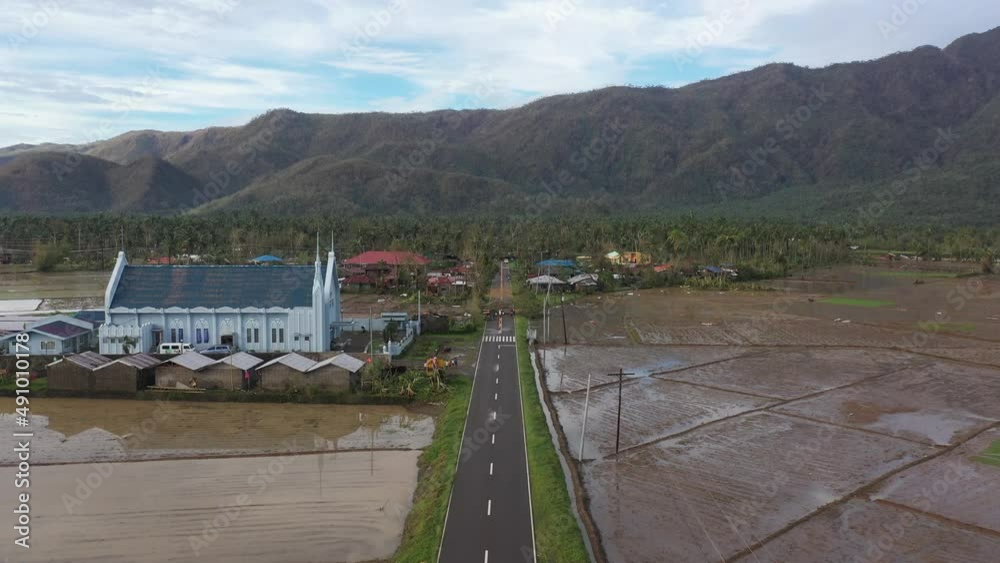 Muddy Rice Field With Church Leading To Provincial Village After ...