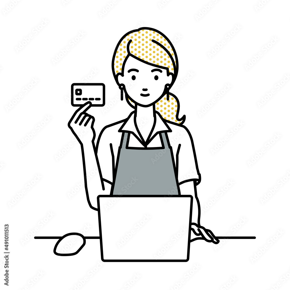 デスクで座ってPCを使いながらクレジットカードを手に持っているカフェ店員の女性 デスクで座ってPCを使いながらクレジットカードを手に持っているカフェ店員の女性