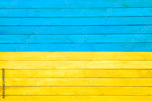 Blue and yellow colors. National colors of Ukraine flag on abstract wooden background