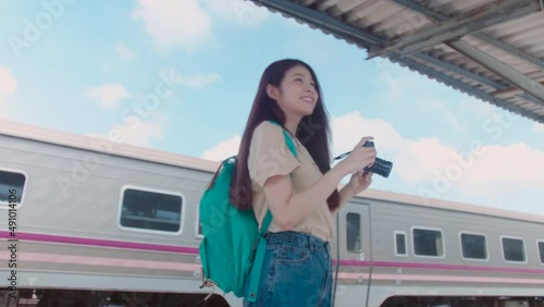 Attractive young Asian woman sweetness tourist take and see a photo on camera together while traveling in Thailand. Gimbal shot movement.