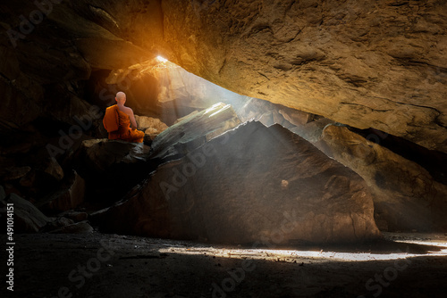 Buddhist monk practice meditation in cave photo