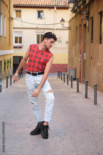 Young caucasian man with long false nails dancing at street, steps of contemporary dance. © Ladanifer