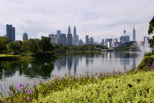 Photography Kuala Lumpur skyline across a tranquil lake — city park view with Petronas Tower