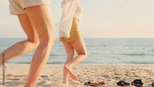 Canvas Print Happy friends holding hands running enjoy life funny and freedom on sand at beac
