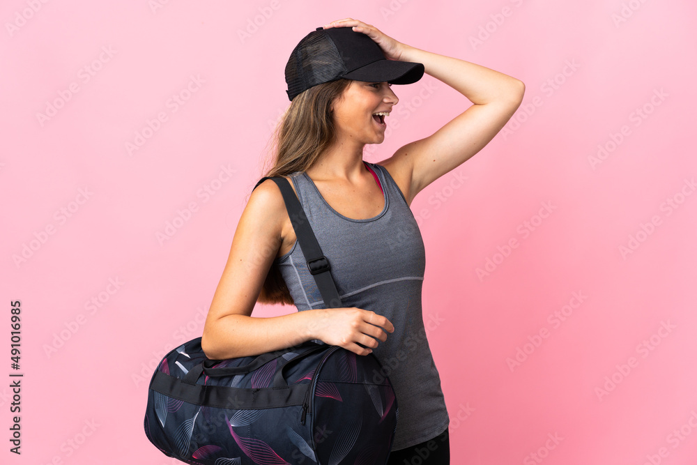 Young sport woman with sport bag isolated on pink background smiling a lot Young sport woman with sport bag isolated on pink background smiling a lot