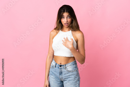 Young caucasian woman isolated on pink background pointing to oneself © luismolinero