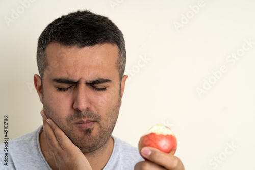 Close up photo of man with toothache or teeth pain. Concept of oral or dental care. Selective focus