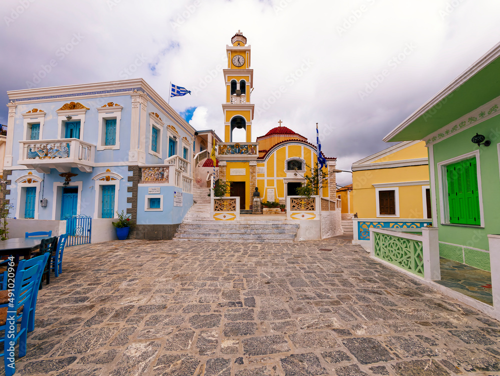 The Colorful Square with the church of the Assumption of the Virgin Mary, Karpathos, Greece.