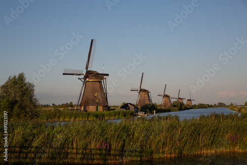 Line of traditional Dutch windmills by the water at Kinderdijk