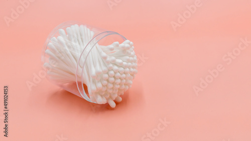 Cotton buds in box on a white background, Top view flat lay swabs cotton buds on orange background with copy space.