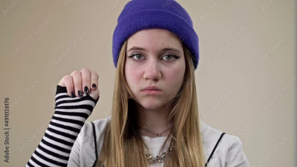 Frightened teenage girl asks for help. A gesture denoting a person's need for help. Frightened teenage girl asks for help. A gesture denoting a person's need for help.