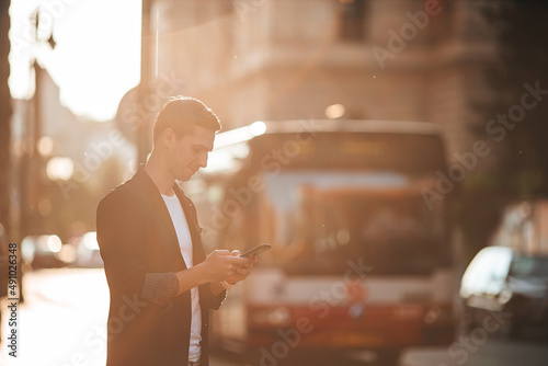 Young caucasian man walking on the street outdoor