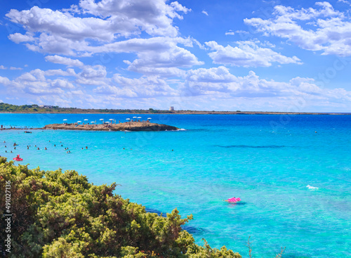 Punta della Suina beach in Salento, Apulia. Italy. It's surrounded by the Mediterranean scrub and by pine forest, boasts two small sandy bays and a small islet, which is almost separated by coast.