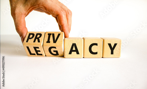 Privacy or legacy symbol. Businessman turns wooden cubes and changes the word Legacy to Privacy. Beautiful white table white background. Business privacy and legacy concept. Copy space.