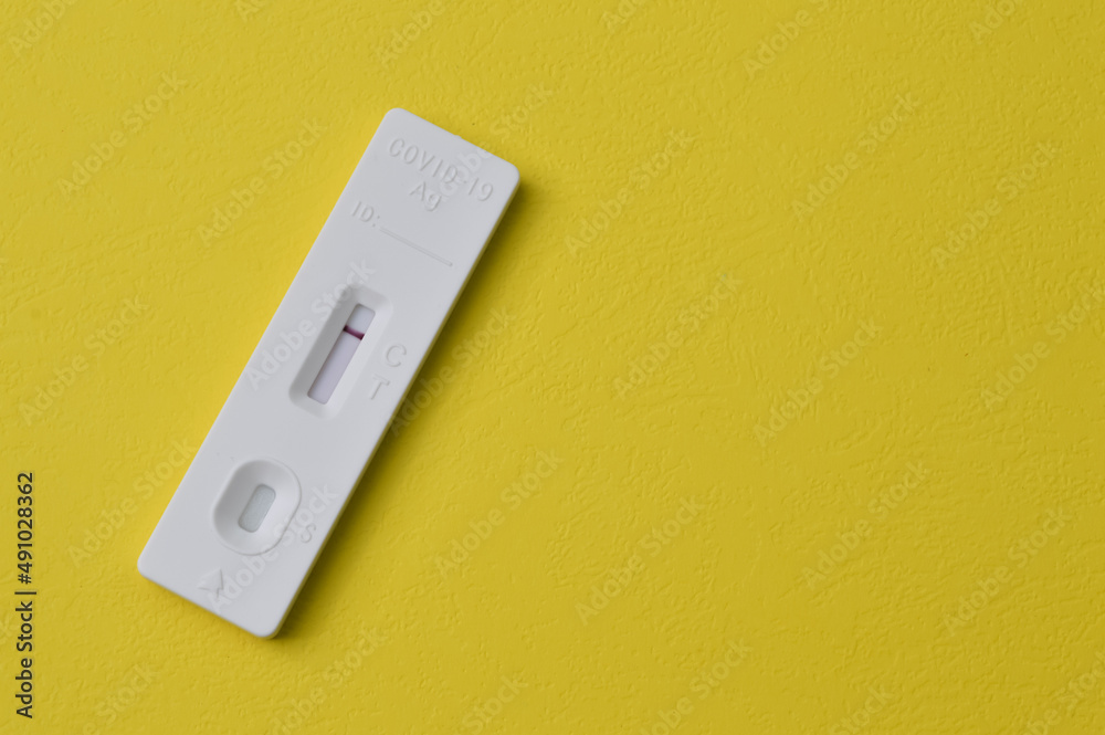Covid-19 Antigen Rapid Test isolated on a yellow backgrund Covid-19 Antigen Rapid Test isolated on a yellow backgrund