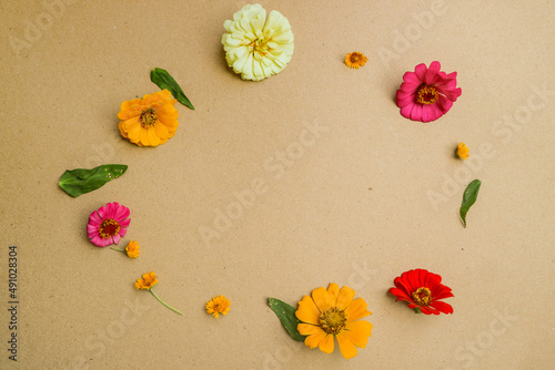 Beautiful flower flat lay arrangement on brown background. Flat lay bouquet, top view, overhead, empty space for copied text.