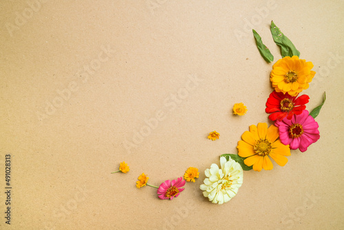 Beautiful flower flat lay arrangement on brown background. Flat lay bouquet, top view, overhead, empty space for copied text.