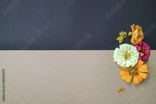 Beautiful flower flat lay arrangement on black and brown background. Flat lay bouquet, top view, overhead, empty space for copied text.