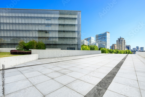 Empty square floor and modern city commercial buildings in Shanghai, China.