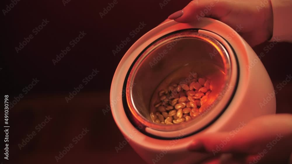 Preparation of gold wax for shugaring. Close-up wax for depilation is heated and melted in a round container