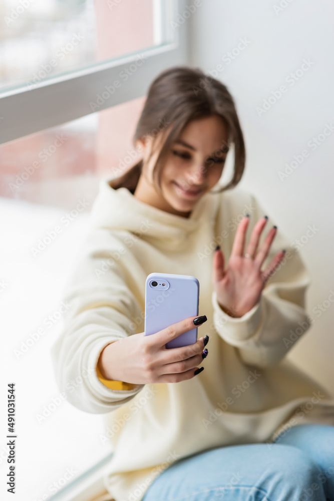 Happy female blogger taking selfie portrait on smartphone camera for social media posting, cheerful teenage girl talking on video call with family or friends via mobile phone.Soft selective focus. Happy female blogger taking selfie portrait on smartphone camera for social media posting, cheerful teenage girl talking on video call with family or friends via mobile phone.Soft selective focus.