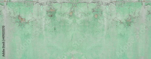 Green wall,abstract background with old green paint texture of plaster and gray cement, panoramic background