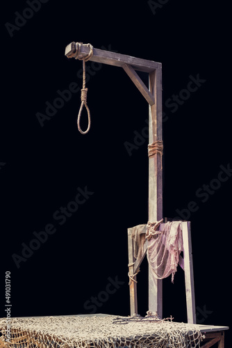 Wooden gallows and loop rope with dark background photo