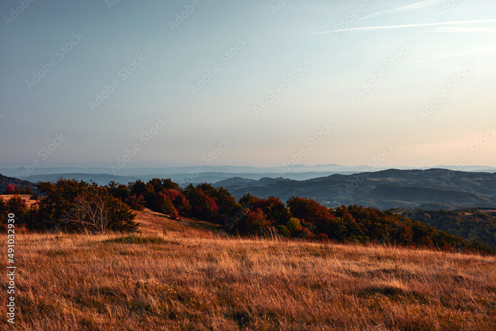 View of countryside hilly landscape in autumn colors.