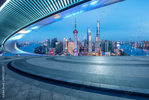 Carta da parati Empty square floor and city skyline with buildings in Shanghai at night, China