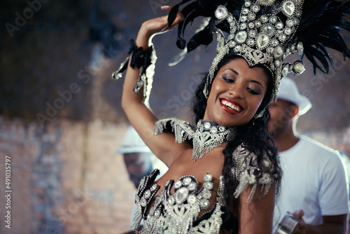 For the joy of samba. Shot of a beautiful samba dancer and her band. photo