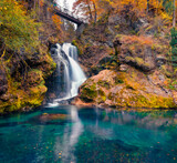Picturesque view of small waterfall in Vintgar Gorge Canyon. Colorful autumn scene of Triglav National Park, Julian Alps, Slovenia, Europe. Beauty of nature concept background.