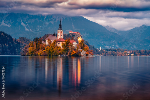 Exciting morning view of Pilgrimage Church of the Assumption of Maria. Gorgeous autumn sunrise on Bled lake, Julian Alps, Slovenia, Europe. Traveling concept background.