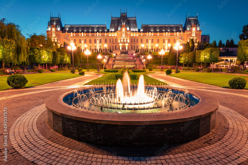 Wonderful evening view of Cultural Palace Iasi. Colorful summer cityscape of Iasi town, capital of  Moldavia region, Romania, Europe. Architecture traveling background.