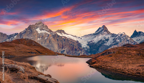 Fantastic evening view of Bachalp lake (Bachalpsee), Switzerland. Amazing autumn sunset in Swiss alps, Grindelwald, Bernese Oberland, Europe. Beauty of nature concept background.