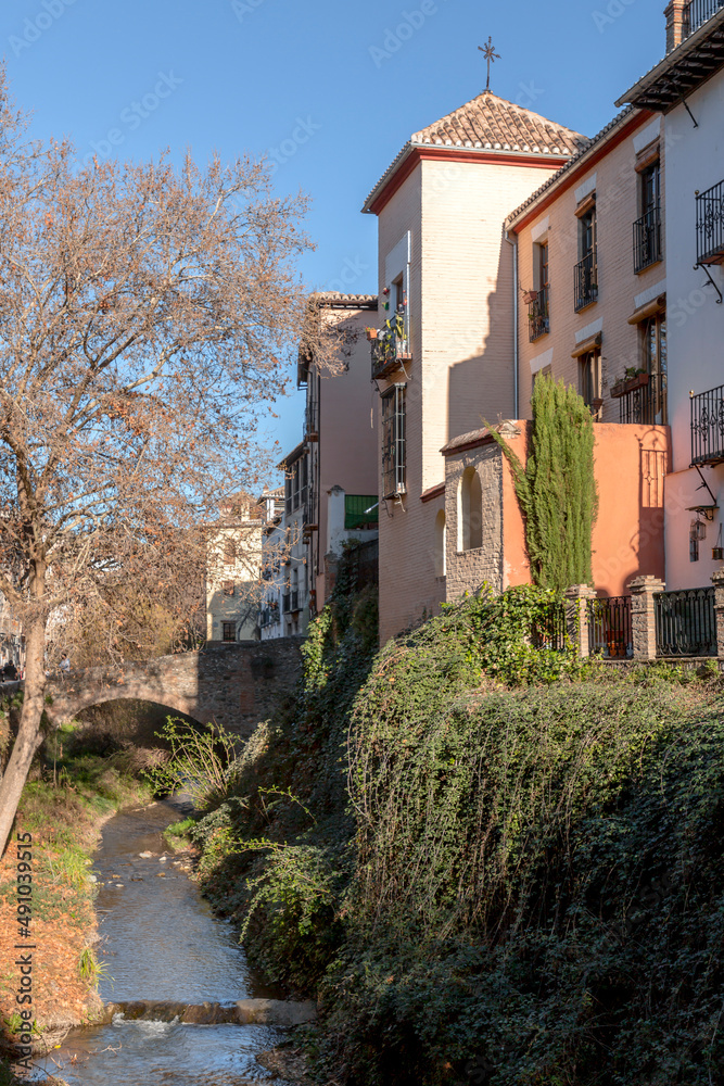 The stone bridge and traditional moorish Spanish architecture around Darro River, Granada, Spain