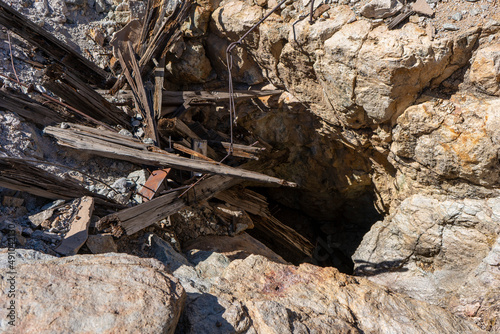A collapsed entrance to an old mine shaft in the mountains of Arizona