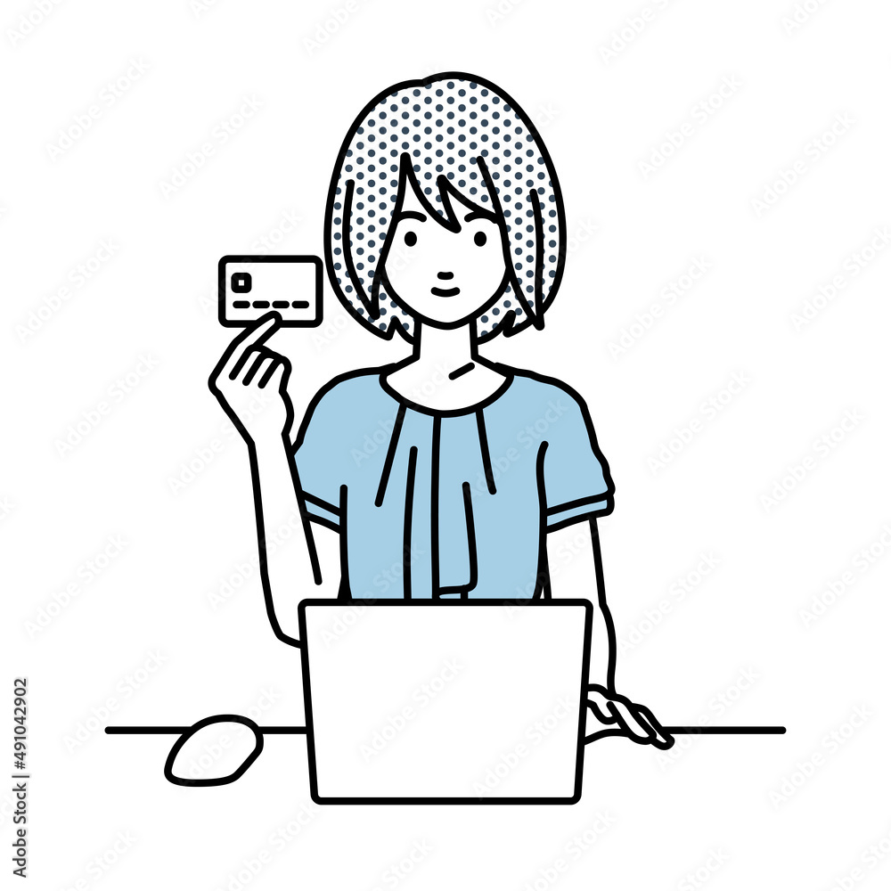 デスクで座ってPCを使いながらクレジットカードを手に持っているオフィスカジュアルの女性