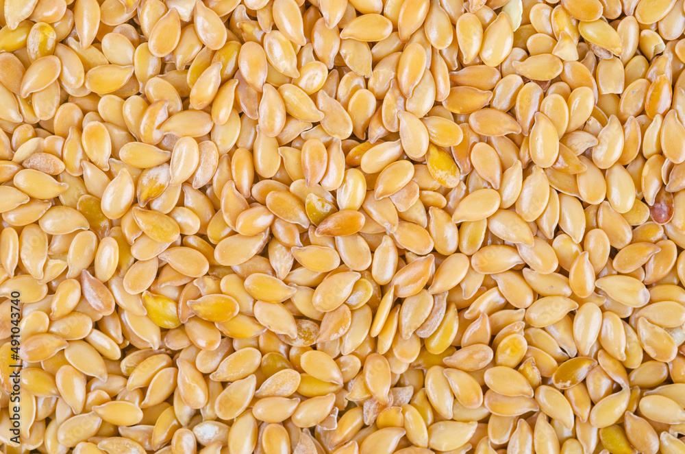 Gold flax seeds texture as background. Gold flax seeds texture as background.