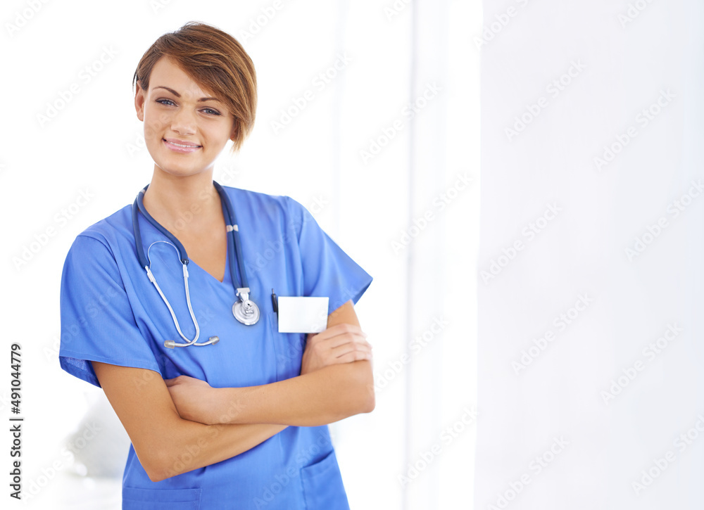 Shes a master in medicine. Portrait of a confident young doctor wearing blue scrubs. Shes a master in medicine. Portrait of a confident young doctor wearing blue scrubs.