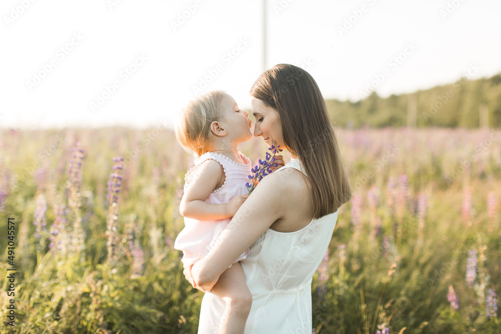 mother holds her child in her arms, nature, calm atmosphere