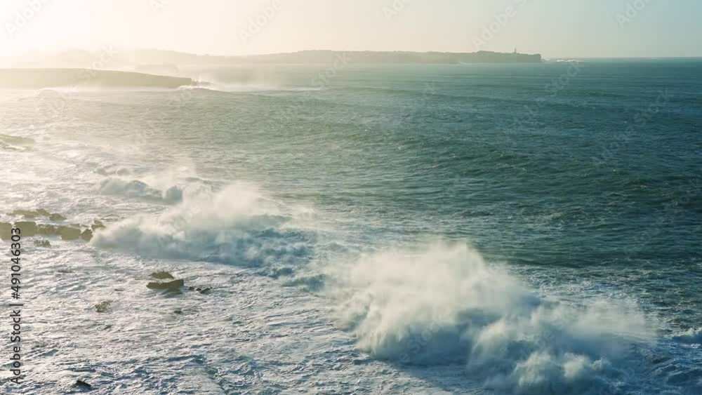 Waves at sunset in the natural pools known as Pozas de Langre. Cantabrian coast in Langre. Cantabria, Spain, Europe