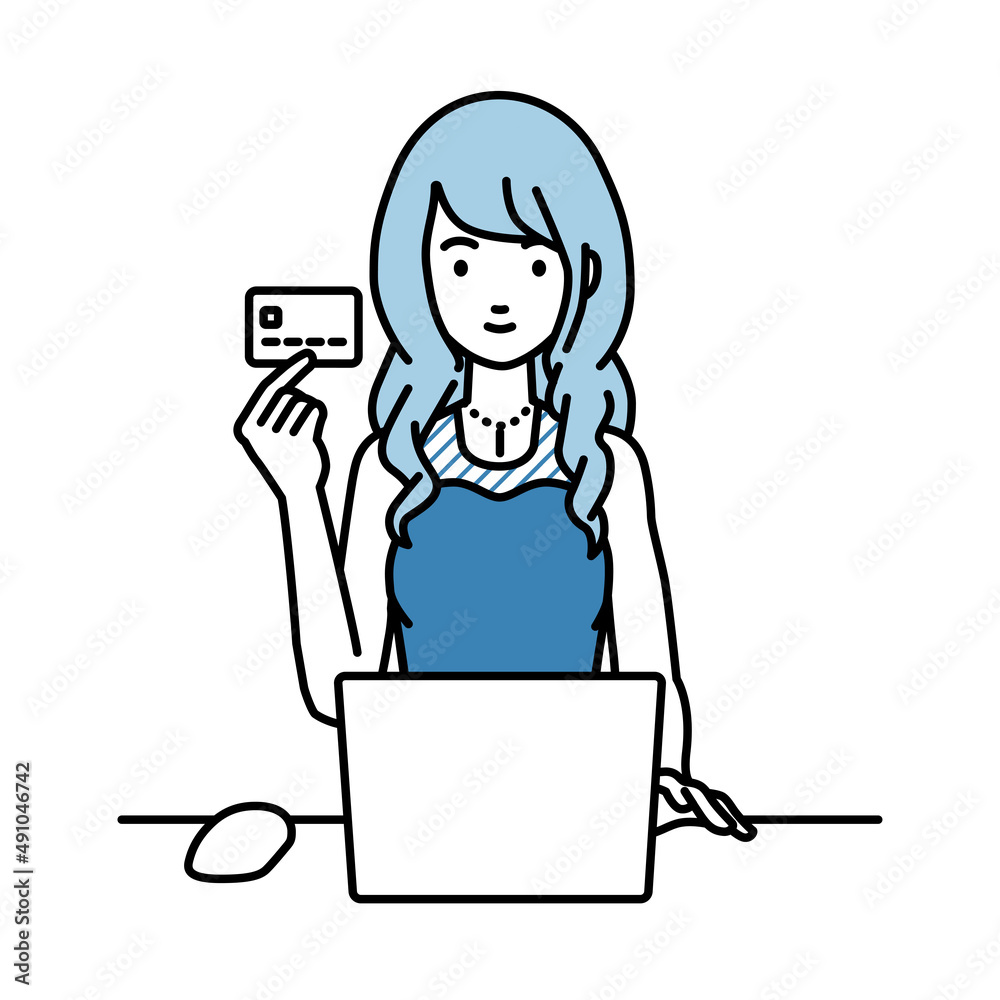 デスクで座ってPCを使いながらクレジットカードを手に持っているドレスの女性