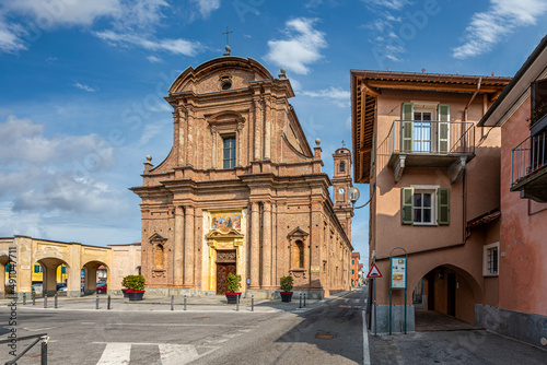 Fossano, Cuneo, Italy - March 06, 2022: parish church of San Filippo (18th century) in piazza Aldo Nicolaj with the arcade and the buildings of the historic center