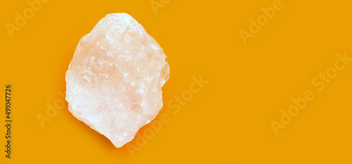 Alum cubes on orange and yellow background, concept for herb, bodycare, skincare, waterclear and protect armpit smell.	 photo