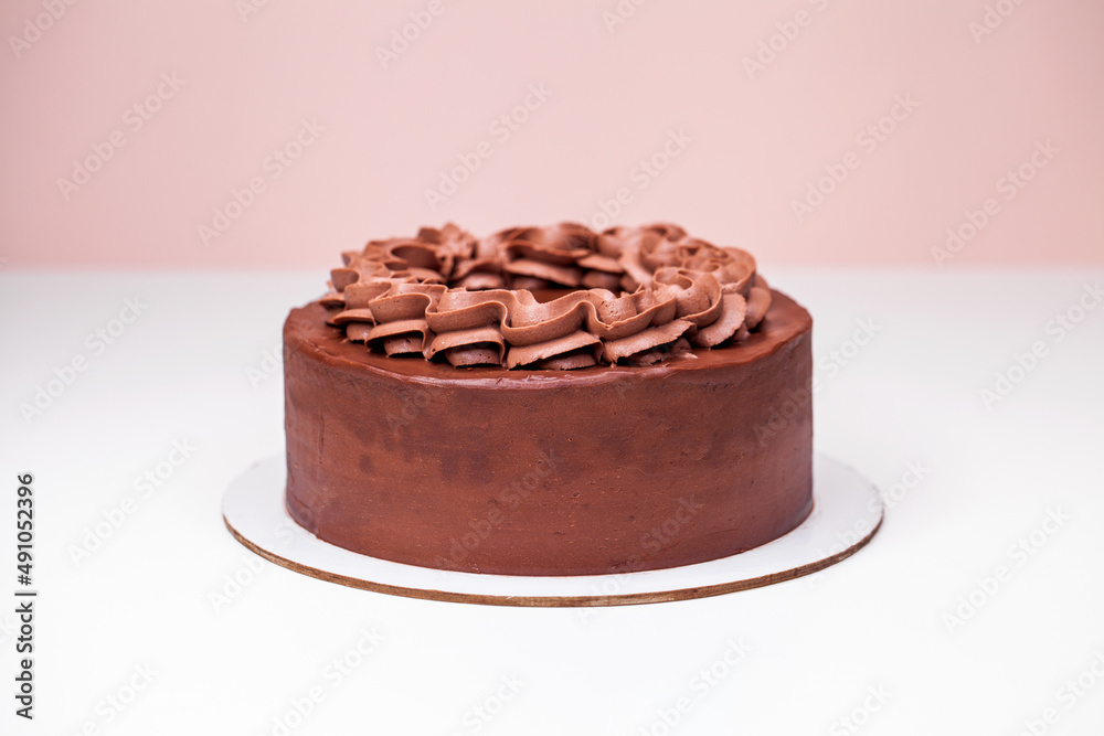 Homemade chocolate cake topped with whipped ganache Homemade chocolate cake topped with whipped ganache