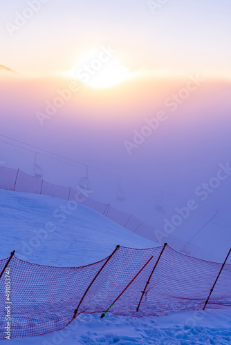 Ski slopes and Ski lifts. Small pine trees with snow. Mountain skiing and snowboarding. View of Erzurum city from Palandoken mountain