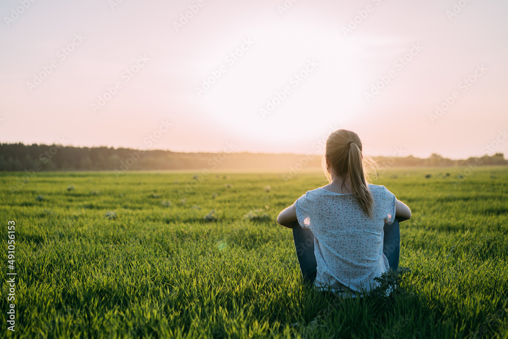 Silhouette of a beautiful Yoga woman on sunrise and rays of light surrounding her Silhouette of a beautiful Yoga woman on sunrise and rays of light surrounding her